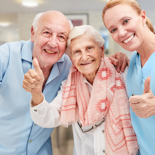 Seniors giving thumbs up for safety at a retirement home with assisted living and memory care