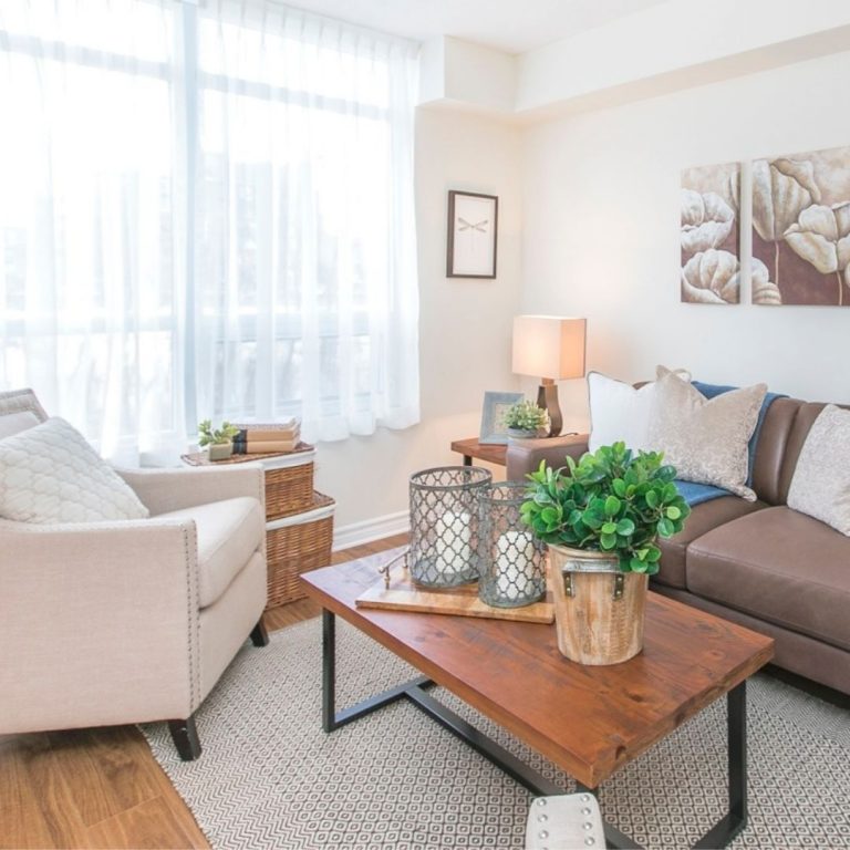Cozy living room with natural light in an independent living apartment at Villagia in the Glebe, Ottawa
